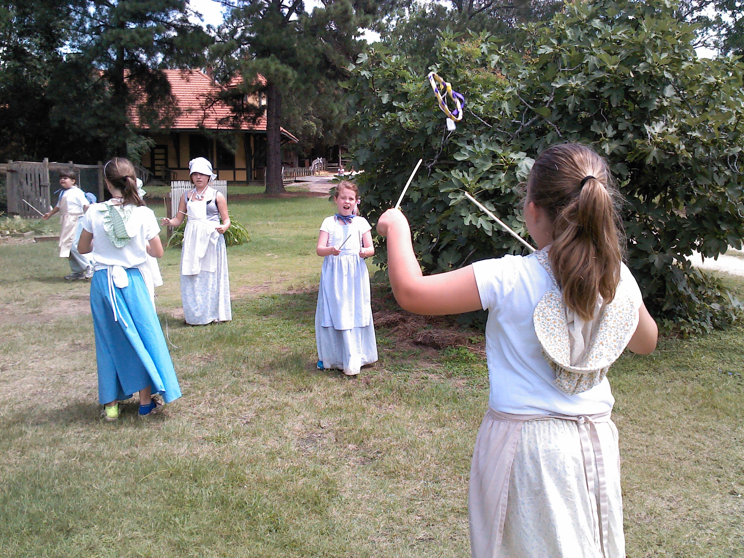 children playing outside dressed in period costume
