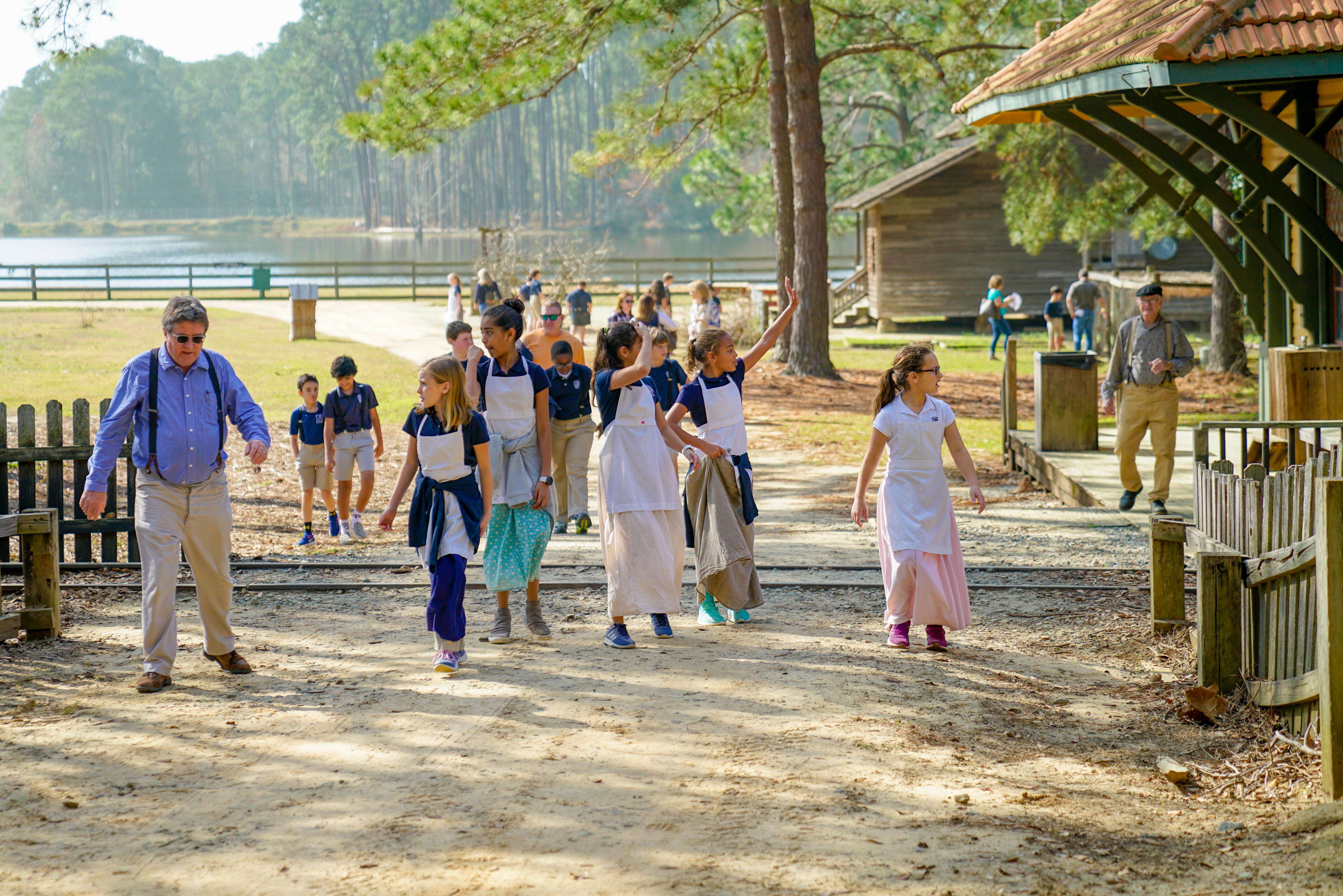 photos of school-age students walking with an interpreter on the grounds of the Georgia Museum of Agriculture