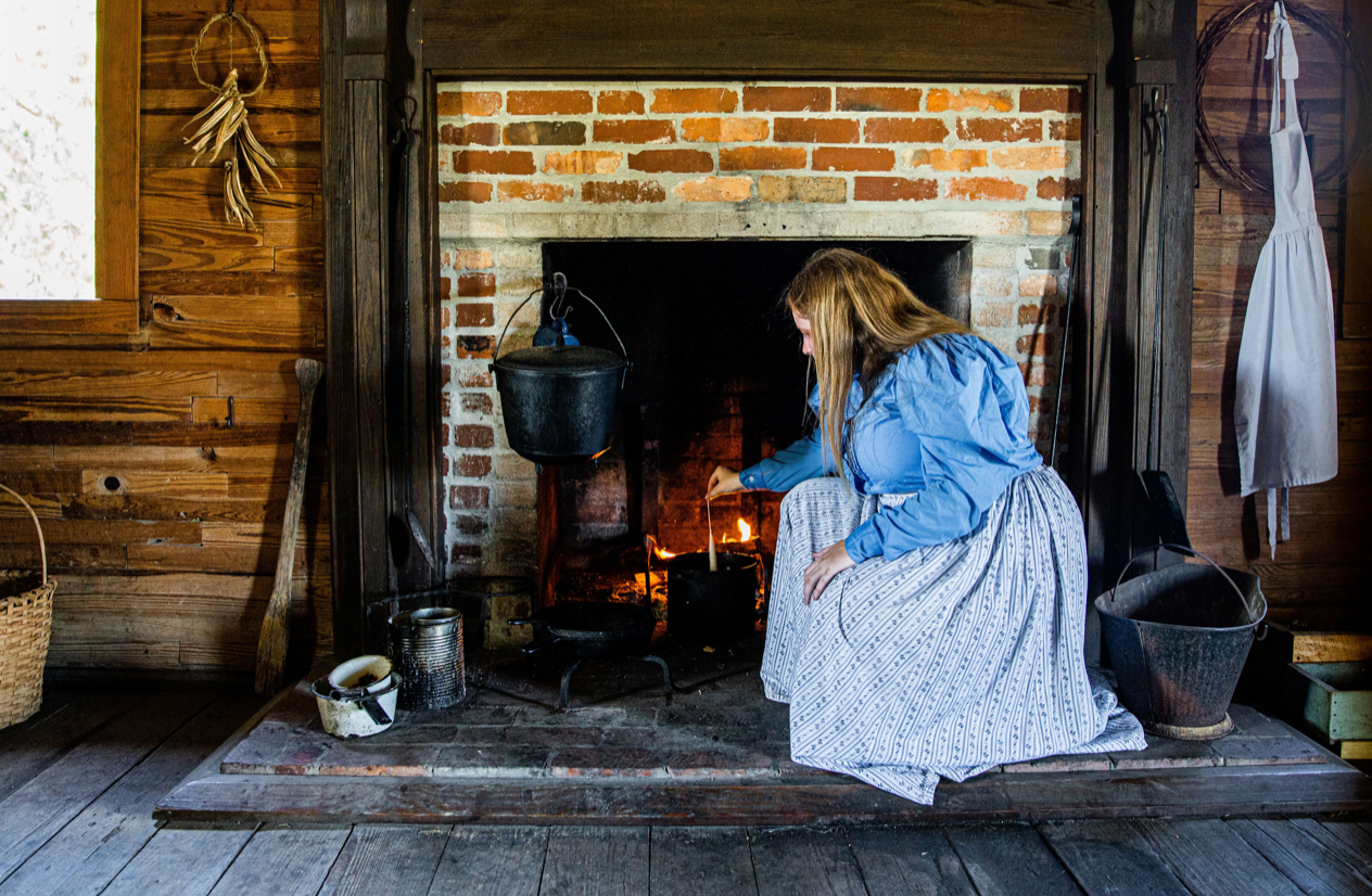 interpreter stoking fire in fireplace